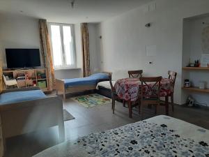 a living room with a couch and a table and chairs at Apartment Alina in Lamone