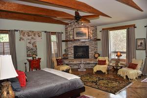 a bedroom with a bed and a fireplace at Rampart Range Resort in Woodland Park