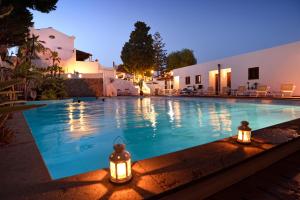 a swimming pool with lights next to a building at Gattopardo Park Hotel in Lipari
