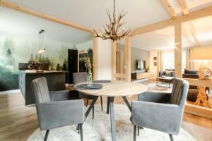 a dining room and living room with a table and chairs at Harzfalke Apartment - Ankommen und wohlfühlen. in Wieda