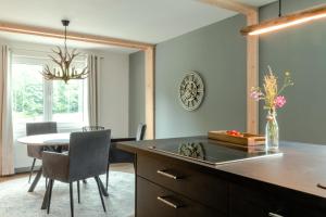 a kitchen with a table and a dining room at Harzfalke Apartment - Ankommen und wohlfühlen. in Wieda +12 photos