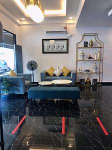 a living room with a blue couch and a table at Hotel VGO in Kuala Lumpur