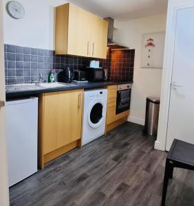 a kitchen with a washer and dryer in it at Lovely 2-Bed Apartment Central Skegness Beach in Skegness