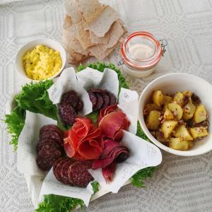 a plate of food with sausage and potatoes and other foods at Sørfjorden Eye Iglo - Fosen in Husby