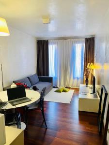 a living room with a couch and a table with a laptop at Suite300 by Palazzina300 in Treviso