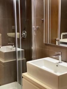 a bathroom with a sink and a shower at Suite300 by Palazzina300 in Treviso +17 photos