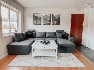a living room with a couch and a table at Apartment with 2bedrooms near the train and buss station in Moss