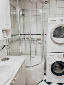 a bathroom with a washing machine and a washer at Apartment with 2bedrooms near the train and buss station in Moss