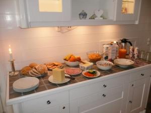 un tavolo per la colazione con cibo e candele sopra di Kullens Bed and Breakfast a Mellby
