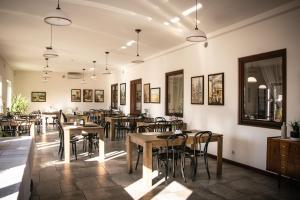 a restaurant with tables and chairs in a room at Hotel Ach To Tu in Leszno