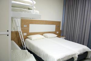 Postel nebo postele na pokoji v ubytování HI - Pkiin Hostel