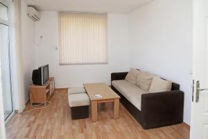 a living room with a couch and a coffee table at Kirovi Apartments in Primorsko