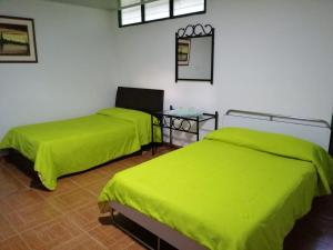 Postel nebo postele na pokoji v ubytování Hospedaje Rancho Guadalupe