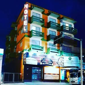 a building with a sign on the side of it at Simar Hotel in Araranguá