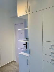 - une cuisine blanche avec des armoires et des appareils blancs dans l'établissement Old Town Apartment Székesfehérvár, à Székesfehérvár