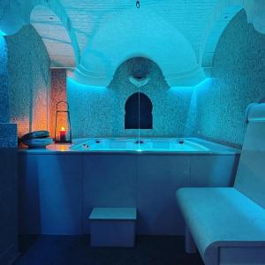 a room with a bath tub with a blue lighting at Villa Angelina in Selva di Fasano
