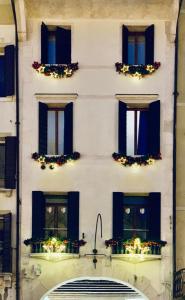 a white building with windows with christmas lights at Suite301 by Palazzina300 in Treviso +20 photos