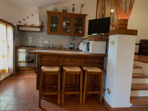 kuchnia z blatem ze stołkami i kuchenką mikrofalową w obiekcie B&B Codivilla w mieście Sasso Marconi