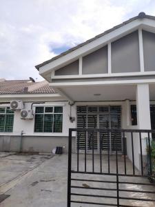 a house with a gate in front of it at Alma Homestay 