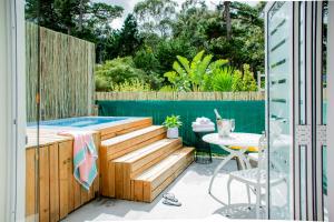 een terras met een dompelbad en een tafel en een tafel met stoel bij Vida Nova Retreat in Hout Baai +61 foto's