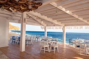 een eetkamer met tafels en stoelen en de oceaan bij Sunrise Remal Beach Resort in Sharm El Sheikh