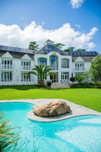 a large house with solar panels on the roof at Vida Nova Retreat in Cape Town