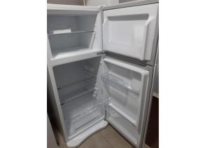 an empty refrigerator with its door open in a kitchen at Departamento en el centro de Bariloche Dx in San Carlos de Bariloche