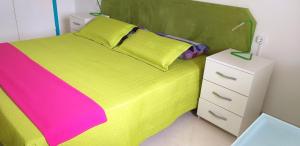 a bedroom with a green bed and a white night stand at Аpartment 1 bedroom center of Las Americas El Dorado in Playa de las Americas