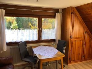 a dining room with a table and a window at Bergwaldhof Schonach in Schonach