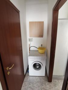 una lavatrice con una ciotola sopra di Appartamento da Luca a Calasetta