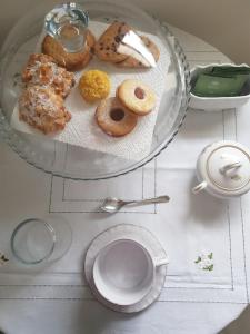 a plate of donuts on a table with a cup of coffee at B&B RoofTop51 in Rimini