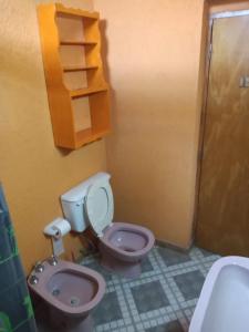a bathroom with a toilet and a sink at El Gringo Tito in La Falda