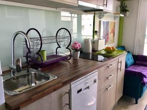 a kitchen with a sink and two baskets on the counter at Studio ocean coast Los Cristianos Comodoro in Los Cristianos