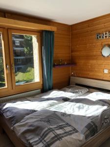 a bedroom with two beds in front of a window at La gentiane in Grimentz