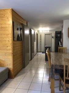 a dining room with a table and a kitchen at La gentiane in Grimentz