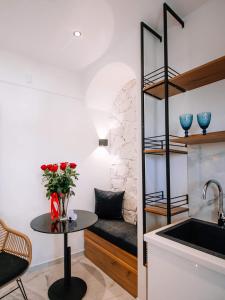 a kitchen with a table and a couch in a room at Kardias Luxury Suites in Iraklitsa