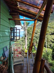 a porch of a house with a swing at Chales Bamboo Jungle in Petrópolis