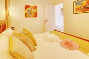 a bedroom with a bed with a hat on it at Orlando - Sea View Apartment in Costa Adeje in Adeje +28 photos