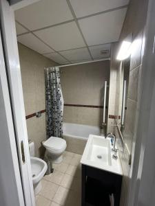 a bathroom with a toilet and a sink at Departamento Oroño in Rosario