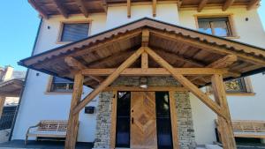 a wooden entrance to a building with a wooden roof at Rocks Schladming in Schladming
