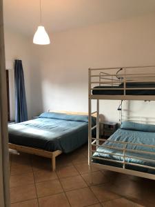 a bedroom with two bunk beds and a lamp at Camera San Jacopo in Altopascio