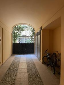 an entrance to a building with a gate and bikes at Una finestra sul centro storico in Reggio Emilia