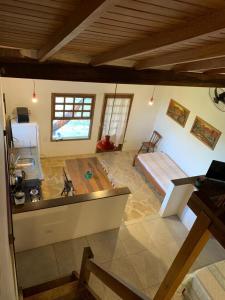 a large living room with a table and a bed at Morada Sunset Praia do Rosa in Praia do Rosa +200 photos
