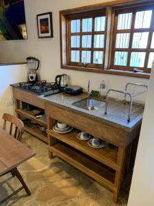 a kitchen with a sink and a counter top at Morada Sunset Praia do Rosa in Praia do Rosa