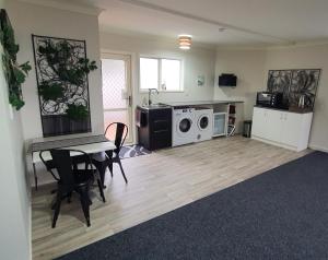 a living room with a table and a microwave at Central Oasis in Tauranga