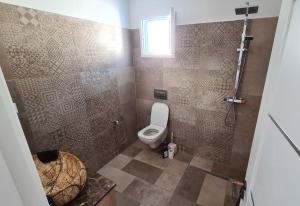 uma casa de banho com um WC e um chuveiro em Villa Bleue plage Sonia em Zarzis