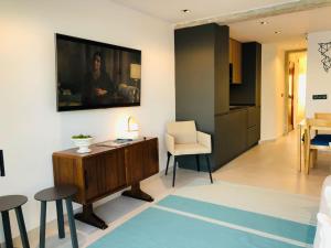 a living room with a desk and chairs in a room at Harbour Views Puerto Denia II in Denia