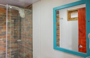 a bathroom with a mirror and a shower at hotel villa claudia in Nobsa