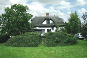 a white house with a gray roof at Altes Backhaus in Groß Zicker