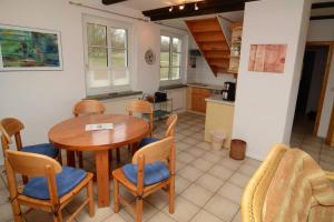 a kitchen and dining room with a table and chairs at Altes Backhaus in Groß Zicker
